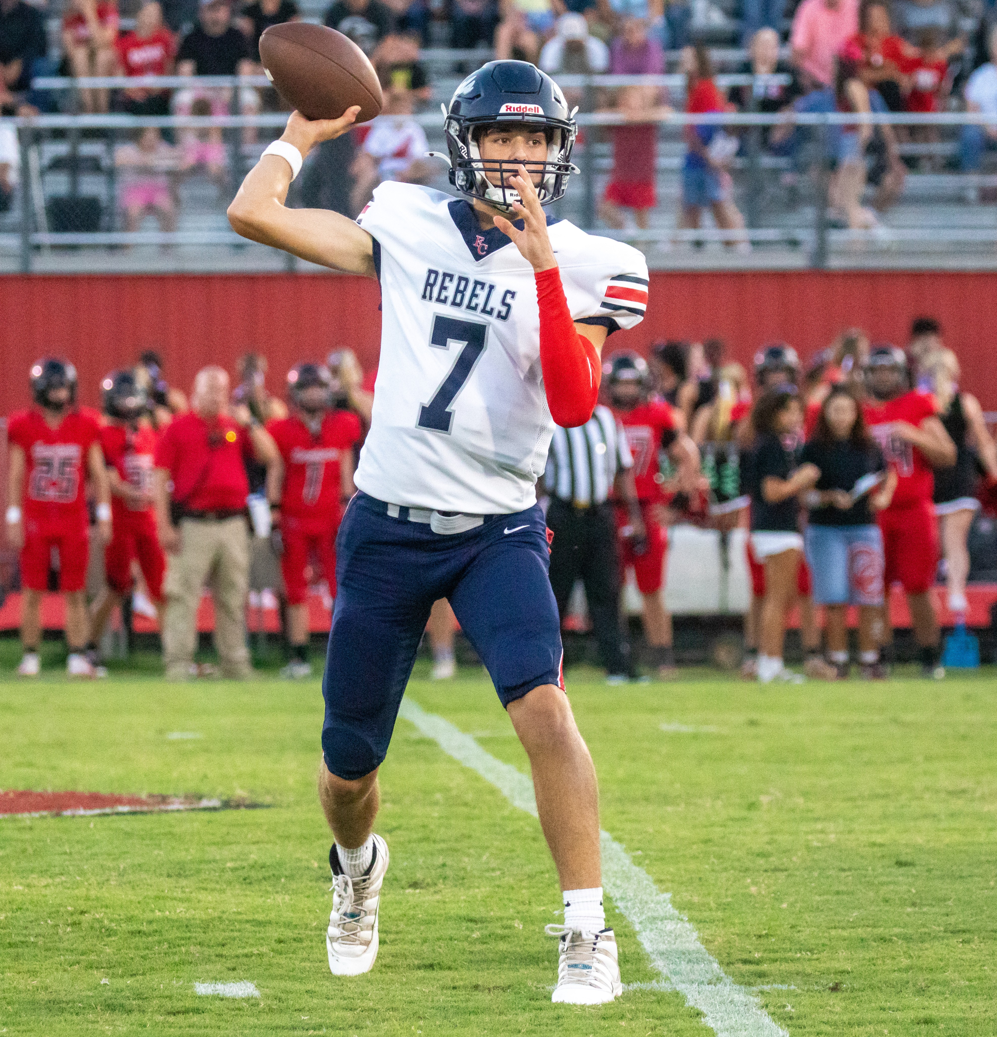 Young athletes competing on the field after the Rebels fall during the high stakes road opener